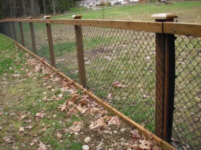 black chain link fence with wood posts