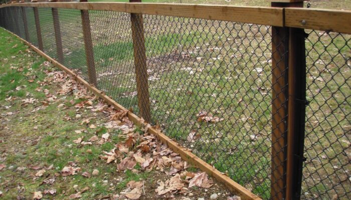 black chain link fence with wood posts